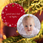 Baby Photo First Christmas Snowflakes New Parents Ceramic Ornament<br><div class="desc">“First Christmas.” A playful visual of white snowflakes and handwritten script typography with customized year, overlaying the photo of your choice, help you usher in Christmas and New Year. On the back, additional white snowflakes and handwritten typography with “proud mom & dad of baby’s name” overlay a red background. Feel...</div>