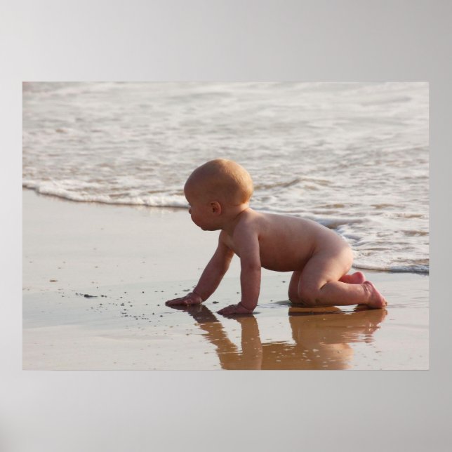 Baby playing in the sand on the beach poster (Front)