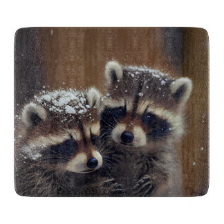 Baby Raccoons Huddle in Falling Snow Glass Cutting Board