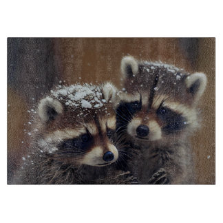 Baby Raccoons Huddle in Falling Snow Glass Cutting Board