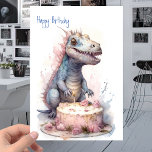 Baby T-Rex Dinosaur with Cake - Kids Birthday Card<br><div class="desc">The baby t-rex dinosaur had been eyeing the birthday cake from across the room since he had arrived at the party. He was determined to get a bite of it, despite the disapproving looks from the other guests. He started to make his way towards the cake, but his mother, sensing...</div>