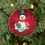 Baby's First Christmas cute snowman black hat  Ceramic Ornament<br><div class="desc">A whimsical Christmas tree ornament featuring an adorable snowman surrounded by delicate snowflakes. Customize it with your child's name and the year for a personalized touch that captures the joy of the season.
Use the "Personalize" button to customize to your liking.</div>