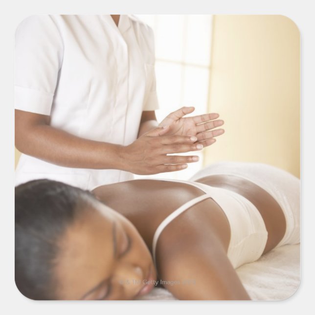 Back massage. Woman receiving a back massage by Square Sticker (Front)