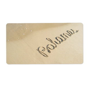 Bahamas carved sign on the beach sand label