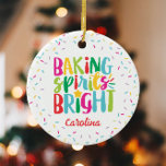 Baking Spirits Bright Colorful Sprinkles Christmas Ceramic Ornament<br><div class="desc">This Christmas design features the text "baking spirits bright" in fun, colorful typography surrounded by a border of rainbow sprinkles! Click the customize button if you would like to move/scale the images and further modify the text! Variations of this design, additional colors, as well as coordinating products are available in...</div>