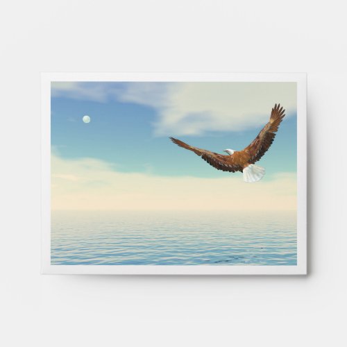 Bald eagle flying upon the ocean to the moon envelope