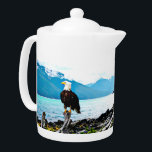 Bald Eagle On Alaska Coast Teapot<br><div class="desc">A digital painting of a bald eagle perched on a driftwood log washed up on the rock-strewn coast of Alaska; mountains loom in the distance. Text reading "Alaska" also appears.</div>