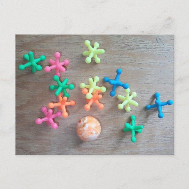 Ball with Colorful Jacks Tossed on Board  Postcard (Front)