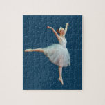 Ballerina in White on Blue Jigsaw Puzzle<br><div class="desc">This little ballerina in her flowing white costume seems to be flying through the air on a background of deep blue. Customize the product by adding a monogram,  caption,  or name.</div>