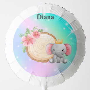 Balloon with elephant sitting next to a log