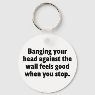 Banging your head against a brick wall keychain