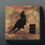 Barrel Racing Girl Silhouette on a Grunge Texture Plaque<br><div class="desc">Exciting and rustic rodeo themed illustration. Silhouette of a cowgirl barrel racing with her horse. Background is a rough weathered brown and red toned earthy grunge texture. Great for rodeo enthusiasts and horse lovers.</div>