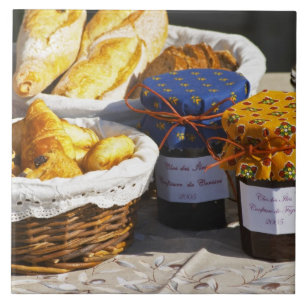 Basket with croissants and chocolate breads. ceramic tile