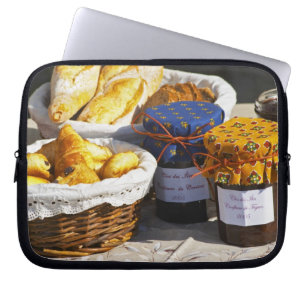 Basket with croissants and chocolate breads. laptop sleeve