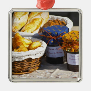 Basket with croissants and chocolate breads. metal ornament