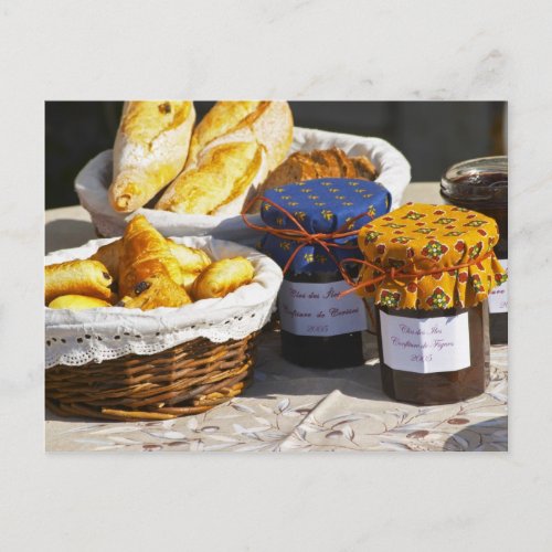 Basket with croissants and chocolate breads postcard