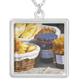Basket with croissants and chocolate breads. silver plated necklace