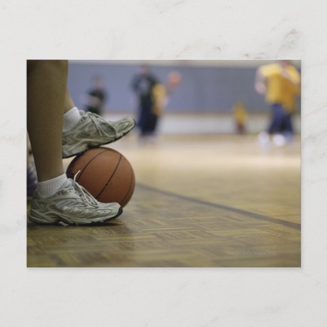 Basketball player holding ball with feet postcard (Front)