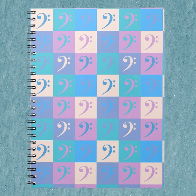 Bass Clef Pattern Pastel Notebook (A notebook with a pattern of bass clef music symbols in blue, yellow, pink and purple.)