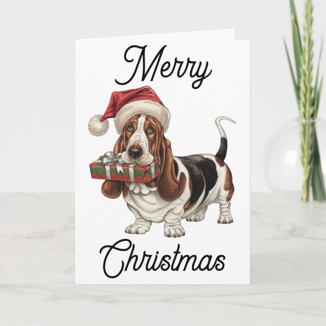 Basset Hound in Santa hat present in mouth Card (Front)