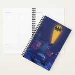 Bat Signal Over Gotham Planner<br><div class="desc">This evocative graphic captures Batman as he oversees Gotham City under the glow of the iconic Bat-Signal. Set against a dramatic night sky, the vibrant yellows and blues create a stark contrast, highlighting the city's sprawling, lit-up skyline and the silhouette of the caped crusader standing vigilant on a rooftop. The...</div>