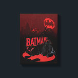 Batman Crimson Rain Canvas Print<br><div class="desc">This atmospheric graphic captures Batman standing resolute under a blood-red sky, an iconic and powerful image of vigilance. The scene is bathed in a monochromatic red tone, highlighted by the stark contrast of Batman's silhouette against the vibrant backdrop. The Bat-Signal is distorted and fragmented in the sky, suggesting Gotham's chaotic...</div>