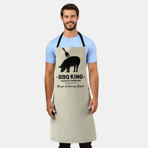 BBQ King Your Name Butcher Kitchen Apron - Manly cooking apron featuring a silhouette of a pig with a fork stuck in it, the words "BBQ king", your name, and another line of text saying "burger and sausage expert".