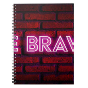 Be brave inspirational quote neon effect text on o notebook