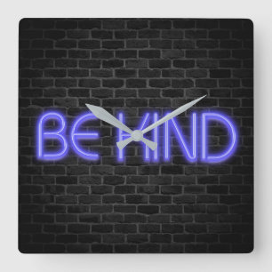 BE KIND text in neon lights on brick Square Wall Square Wall Clock