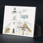 Be the Light Lighthouse Watercolor Faith Quote Plaque<br><div class="desc">Be the Light Lighthouse Watercolor Faith Quote that is encouraging and motivating. The subtle shades of blue, gray, and brown blend beautifully in this peaceful setting, that paraphrases the Bible verse found in Matthew 5:14. It makes a thoughtful Christian gift idea, and is part of a collection found in the...</div>