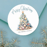 Beach Christmas Classic Round Sticker<br><div class="desc">Celebrate in sunny style with this festive round sticker, perfect for your beachy holiday celebration. A large Christmas tree made of beach shells, starfish, and coral sits in the center, bringing a fun and whimsical coastal vibe to your event. The design features a teal blue and tan color palette that...</div>