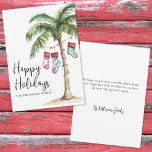 Beach Christmas Happy Holiday Card<br><div class="desc">Get into the holiday spirit with this festive watercolor Christmas card featuring a large palm tree wrapped in colorful Christmas lights. Three holiday stockings hang playfully from the fronds, while soft beach sand rests at the base—bringing a warm and tropical twist to your holiday greetings. The front features "Mele Kalikimaka"...</div>