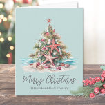 Beach Christmas Tree Holiday Card<br><div class="desc">Happy Holidays! Share some coastal cheer with this folded holiday card featuring a festive Christmas tree made of seashells and topped with a starfish. The design has a teal blue background on both the front and back, with gray and black fonts for a clean, coastal-inspired look. The watercolor artwork includes...</div>