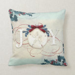Beach Coastal Christmas Joy Sand Dollar Blue Holly Throw Pillow<br><div class="desc">"Beach Coastal Christmas Joy Sand Dollar Holly with red glitter flourishes and a burgundy bow, throw pillow." Elegant watercolor design with a textured sand and sea background, holly in blue and red with the typography design, "JOY" in off white. Red glitter accents the calligraphy scrolls and a burgundy bow finishes...</div>