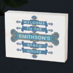 Beach House Blue Coastal Vintage Style Custom Name Wooden Box Sign<br><div class="desc">This unique beach house wooden box sign has a vintage-style banner in blue with your personalized text. The coastal design is trimmed in sea shells, a gold-yellow rope and plenty of elegant flourishes. The text currently reads, "Welcome to the [Your Name]'s Beach House." Use the easy templates to add your...</div>