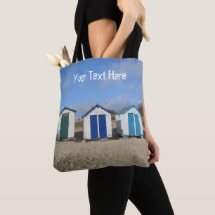 Beach huts blue skies sand english seaside tote bag