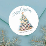 Beach Merry Christmas Classic Round Sticker<br><div class="desc">Celebrate in sunny style with this festive round sticker, perfect for your tropical holiday celebration. A large Christmas tree made of beach shells, starfish, and coral sits in the center, bringing a fun and whimsical coastal vibe to your event. The design features a teal blue and tan color palette that...</div>