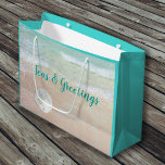Beach Ornaments Seas n Greetings Large Gift Bag<br><div class="desc">Large Christmas gift bag with beach background on both sides. Customize the wording on the front - sample text is “Seas and Greetings” with a white sand dollar on the beach sand design. The back of the bag also has a tropical beach image with three blue tree ornaments hanging from...</div>