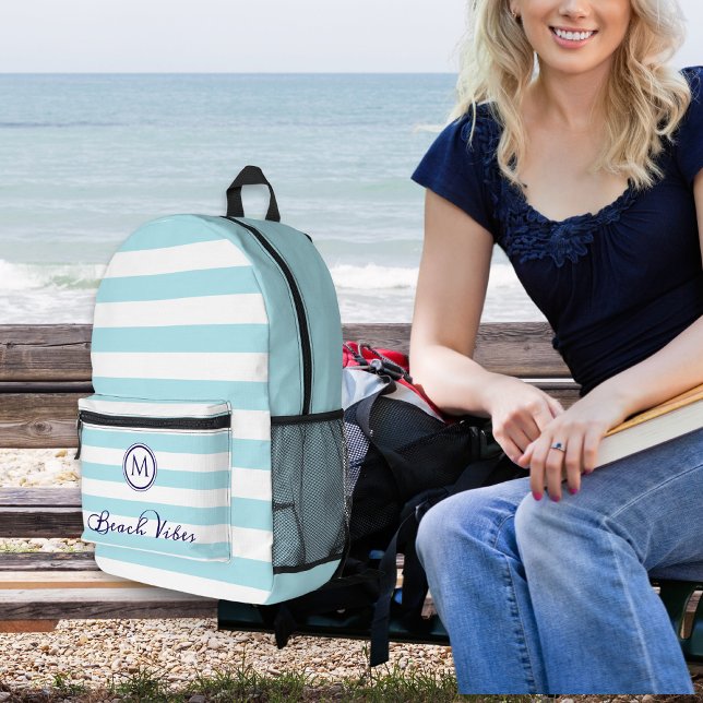 Beach Vibes Coastal Stripes Nautical Monogram Printed Backpack (A backpack with blue and white striped front, monogram initial and 'Beach Vibes' caption)