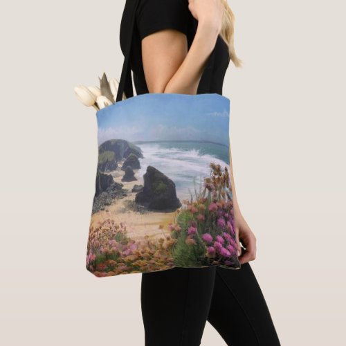 Beach view from cliffs with pink flowers tote bag