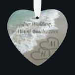 Beach Wedding Keepsake Interlocking Hearts Ornament<br><div class="desc">Elegant Sand Hearts written in the Beach nice to symbolize a Destination Wedding or tropical honeymoon travel vacation. Beautiful scenic image of clear aqua turquoise ocean water, with white waves crashing on the tan sand beach. Two interlocking hearts symbolize eternal love, even put your custom first or last name initials...</div>