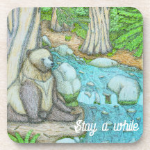 Bear sitting by a creek