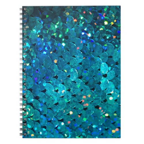 Beautiful and colorful sequins sparkling under the notebook
