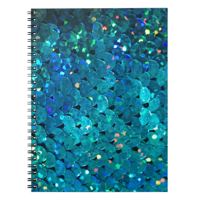 Beautiful and colorful sequins sparkling under the notebook (Front)
