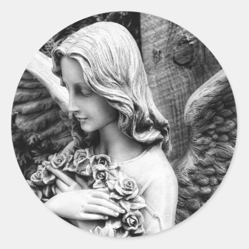 Beautiful angel holding roses on her chest classic round sticker