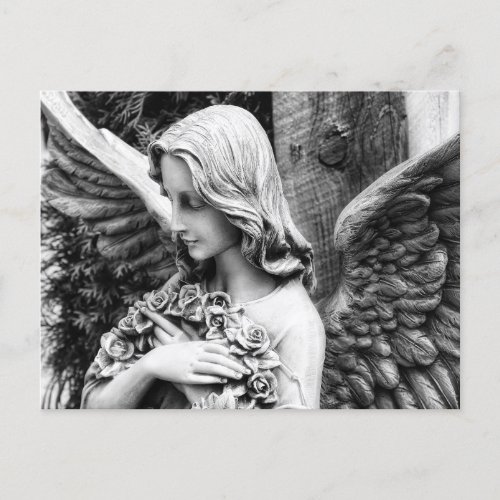 Beautiful angel holding roses on her chest postcard