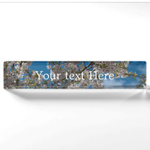 Beautiful cherry blossoming tree against blue sky. nameplate