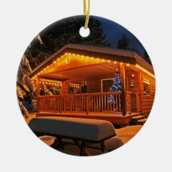 Beautiful Christmas Lights On Log Cabin In Snow Ceramic Ornament by UniqueChristmasGifts at Zazzle