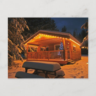 Beautiful Christmas Lights on Log Cabin in Snow Holiday Postcard