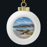 Beautiful Laguna Beach Ceramic Ball Christmas Ornament<br><div class="desc">This ornament makes a unique keepsake to remember any visit to fabulous Laguna Beach.  Change the date to the current year.  The font style can be changed as well as the size,  color and location.  Three options for the back image also.</div>